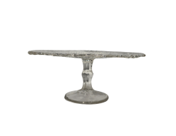 Crystal Heirloom Cake Stand for rent at Violet Vintage Indianapolis: A vintage-style pressed glass cake pedestal featuring an intricately patterned clear glass plate with scalloped edges and a matching tapered base for event dessert displays.