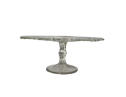 Crystal Heirloom Cake Stand for rent at Violet Vintage Indianapolis: A vintage-style pressed glass cake pedestal featuring an intricately patterned clear glass plate with scalloped edges and a matching tapered base for event dessert displays.