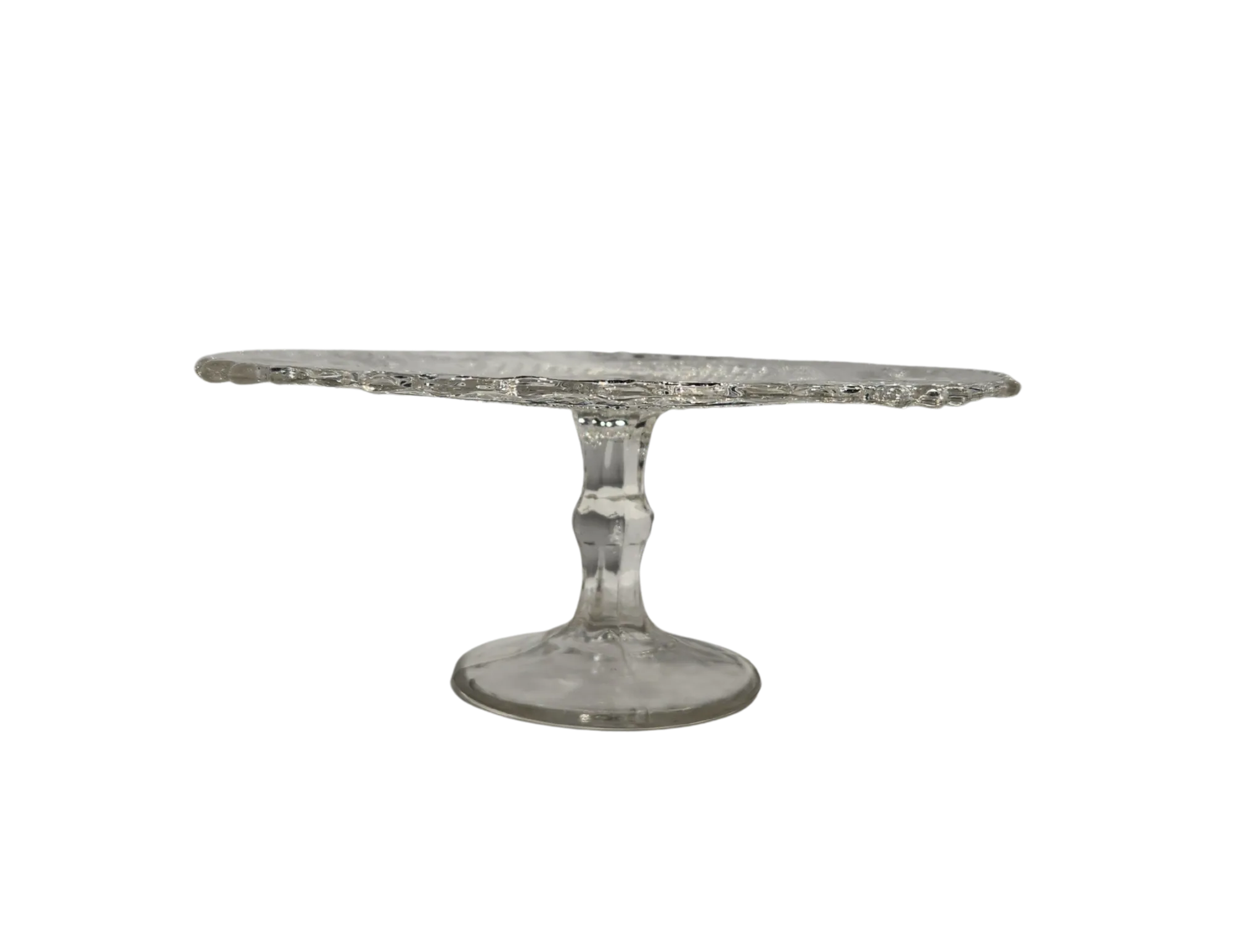 72 WEBP Crystal Heirloom Cake Stand for rent at Violet Vintage Indianapolis: A vintage-style pressed glass cake pedestal featuring an intricately patterned clear glass plate with scalloped edges and a matching tapered base for event dessert displays.
