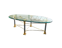 Shagri Coffee Table for rent at Violet Vintage Indianapolis: A Regency-style oval glass coffee table featuring a beveled edge and an ornate mixed-metal base with gold-finished carved capitals, silver pillars, and gold-sculpted feet.