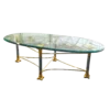 Shagri Coffee Table for rent at Violet Vintage Indianapolis: A Regency-style oval glass coffee table featuring a beveled edge and an ornate mixed-metal base with gold-finished carved capitals, silver pillars, and gold-sculpted feet.