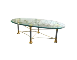 Shagri Coffee Table for rent at Violet Vintage Indianapolis: A Regency-style oval glass coffee table featuring a beveled edge and an ornate mixed-metal base with gold-finished carved capitals, silver pillars, and gold-sculpted feet.