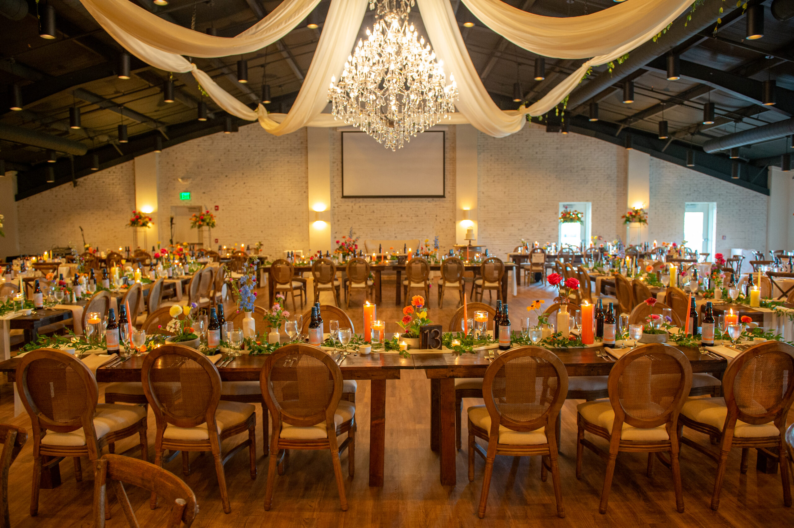 Louis Cane Back Chairs set around long reception tables at an Indianapolis wedding