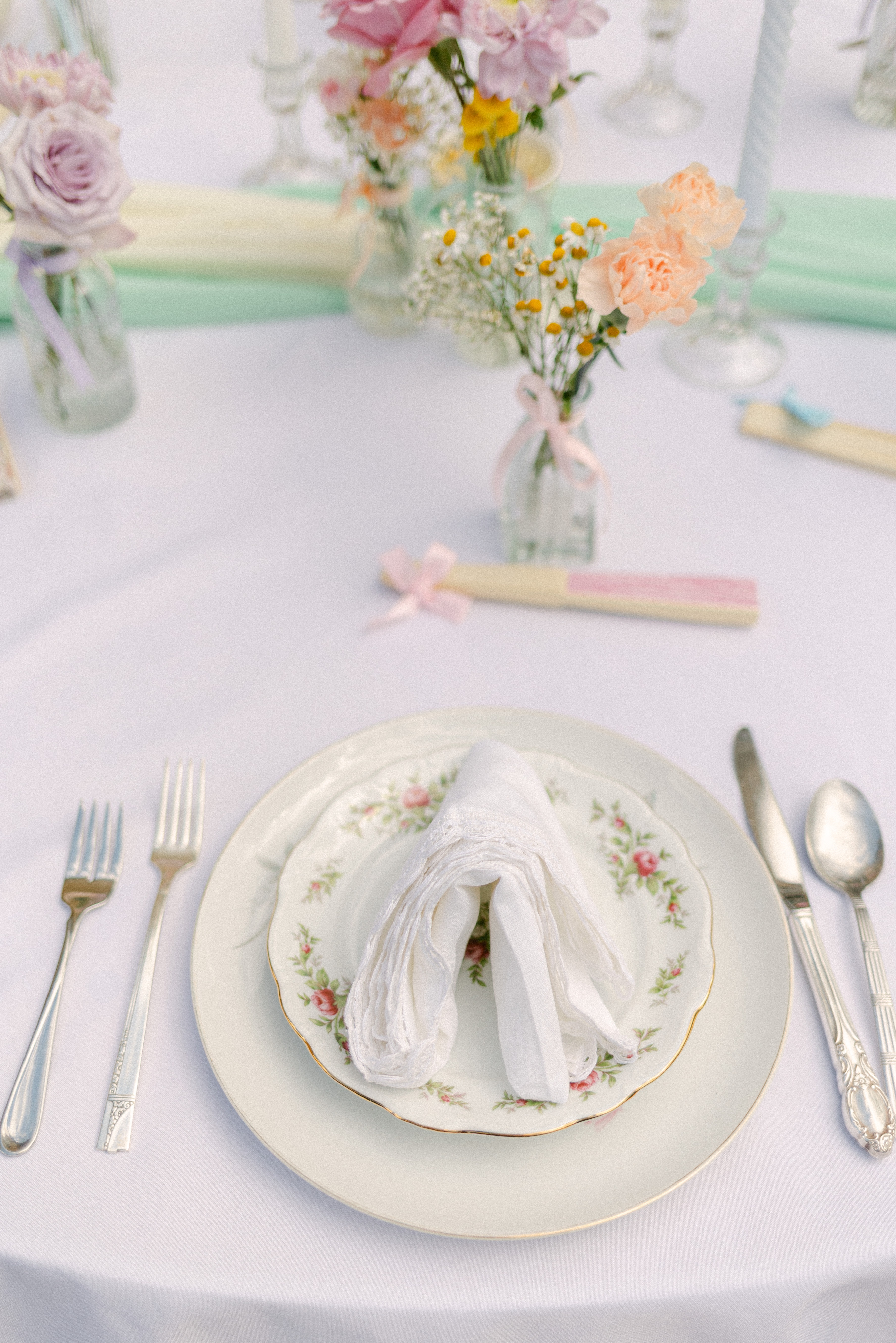 Pink Vintage Mismatched China Plates layered at a wedding place setting