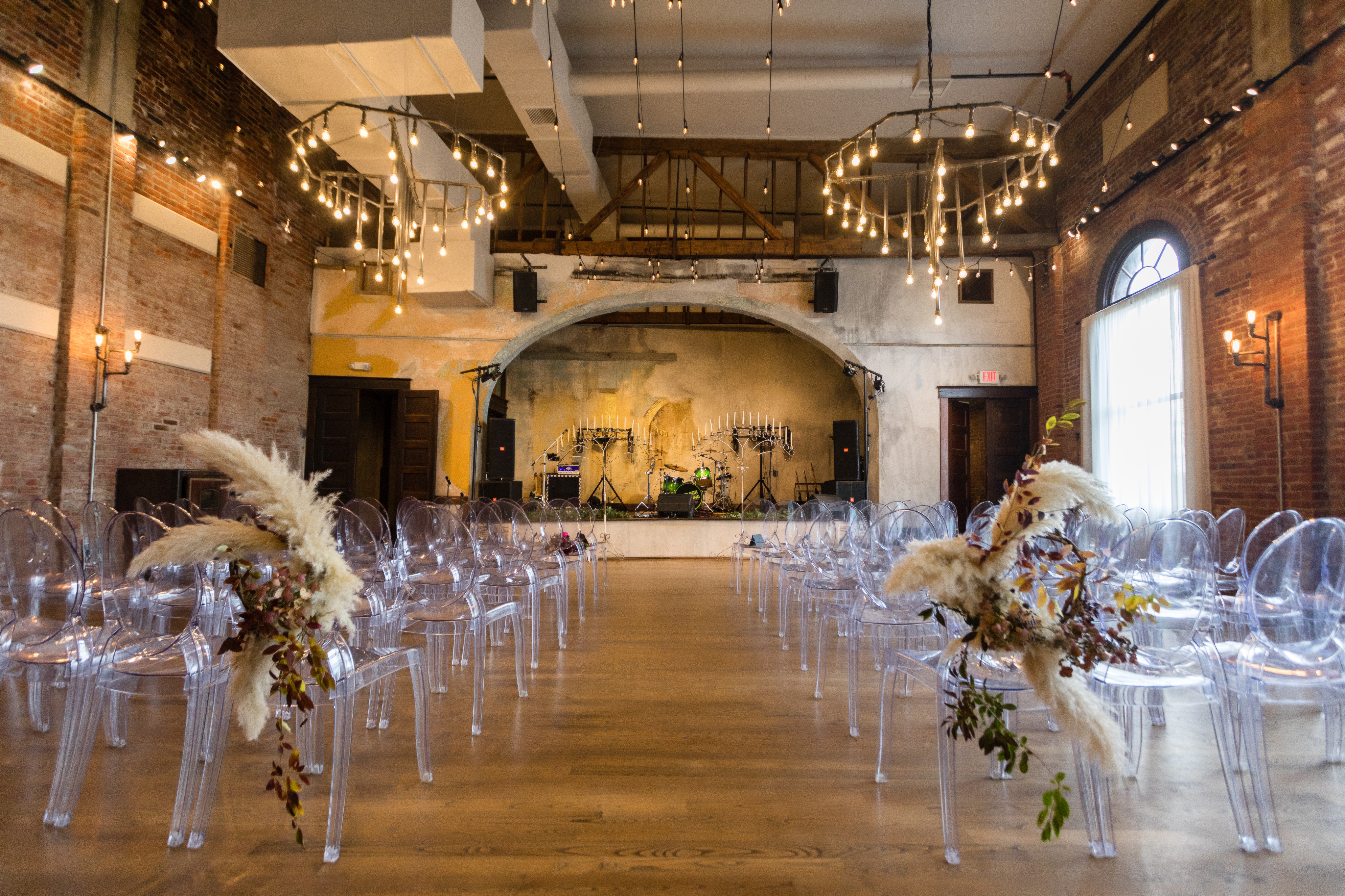 Ghost Chairs arranged at a brick-walled Indianapolis wedding reception
