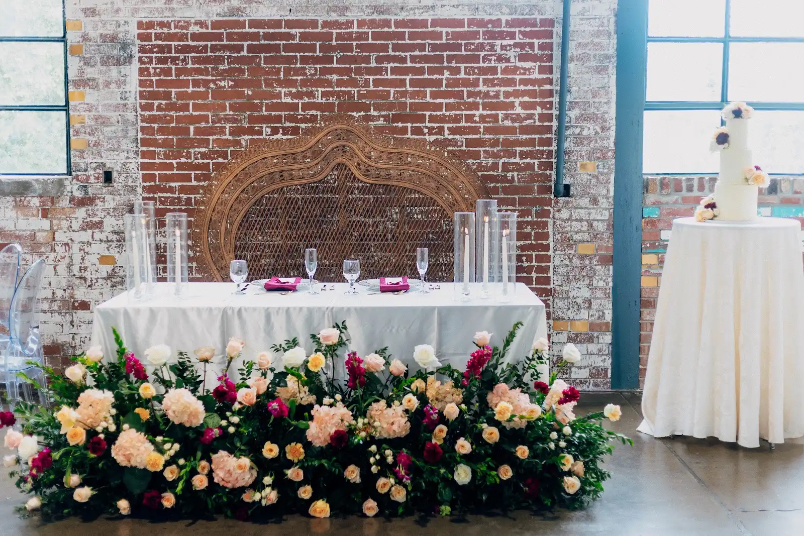 Nasrina Double Peacock Chair behind Folake and Aloy's floral wedding head table at VV Showroom in Indianapolis