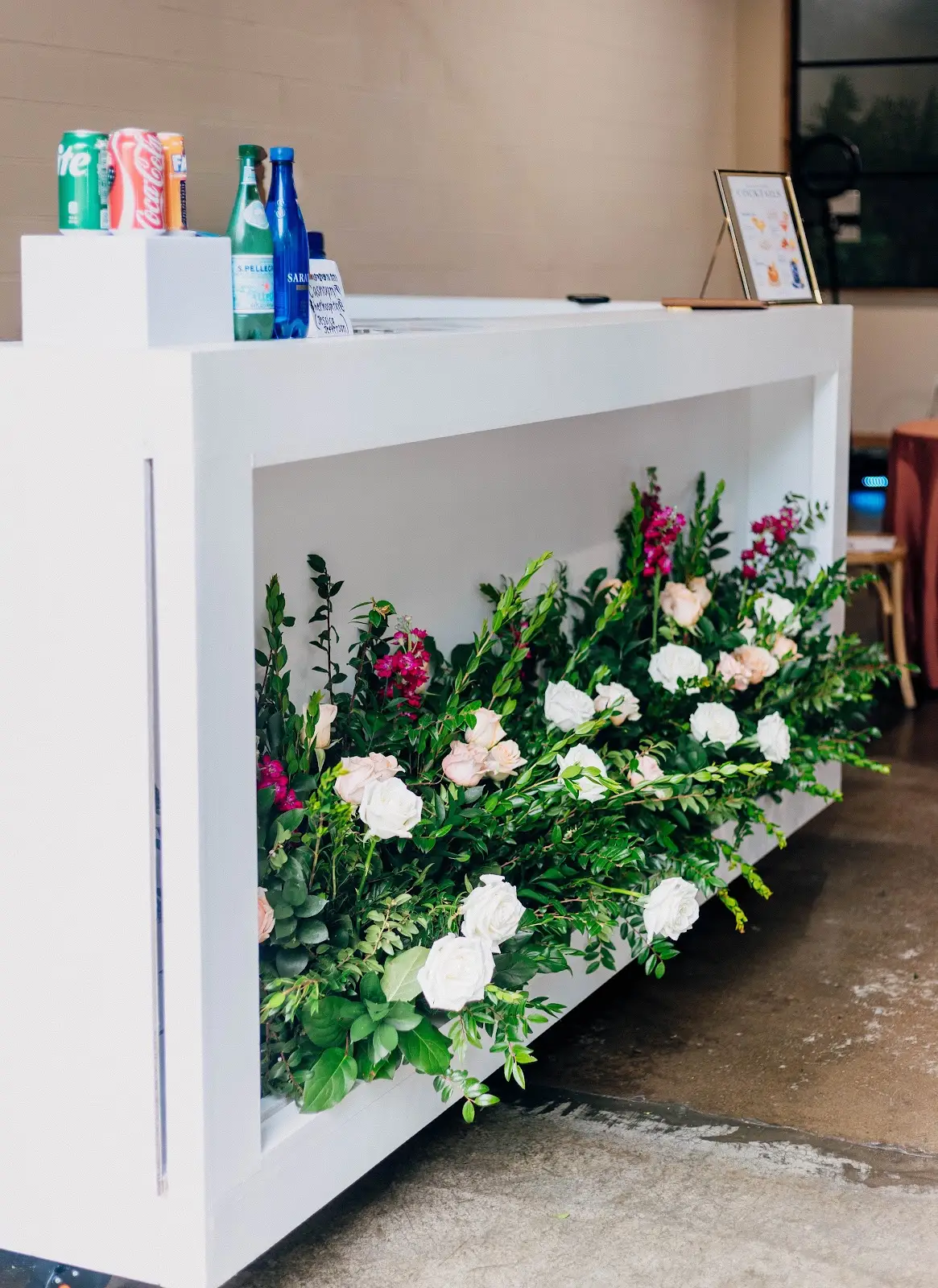 White Bar with a floral arrangement at Folake and Aloy's intimate wedding at VV Showroom