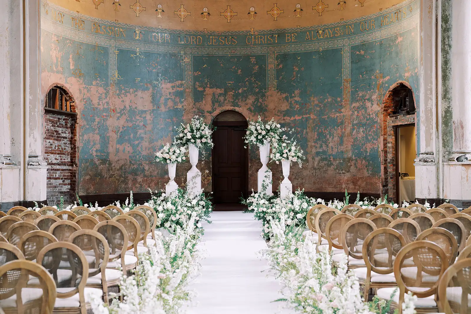 Louis cane back chairs arranged for a wedding ceremony by Violet Vintage Rentals