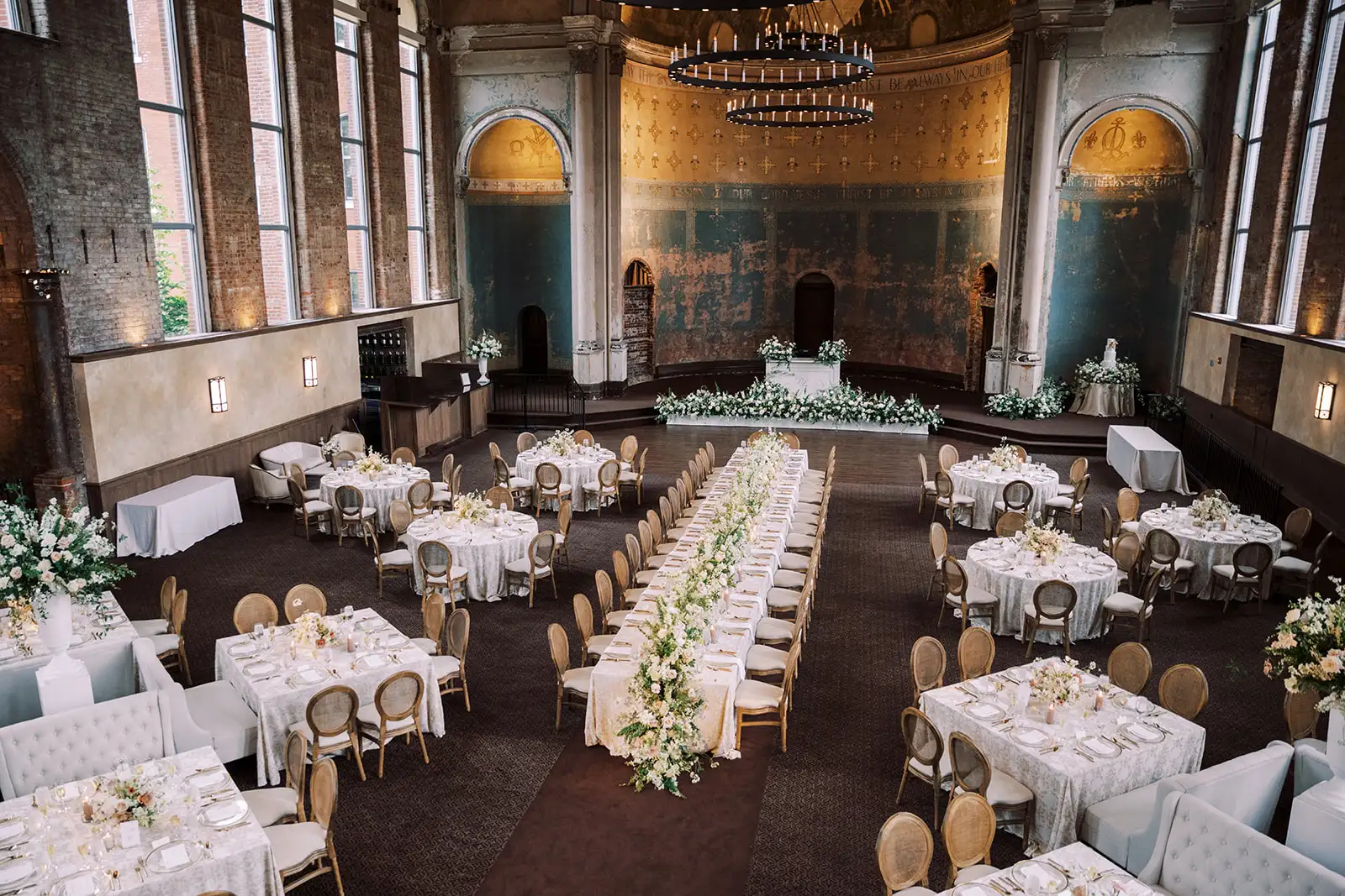 Louis cane back chairs reset around wedding reception tables