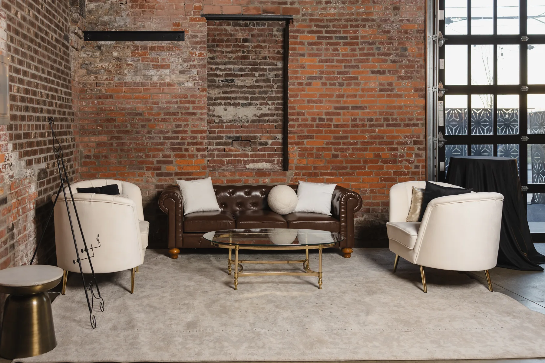 Corporate event lounge with Colden Sofa, Divani Chair, Gia Coffee Table, and Sade Side Table by Violet Vintage Rentals at INDUSTRY in Indianapolis