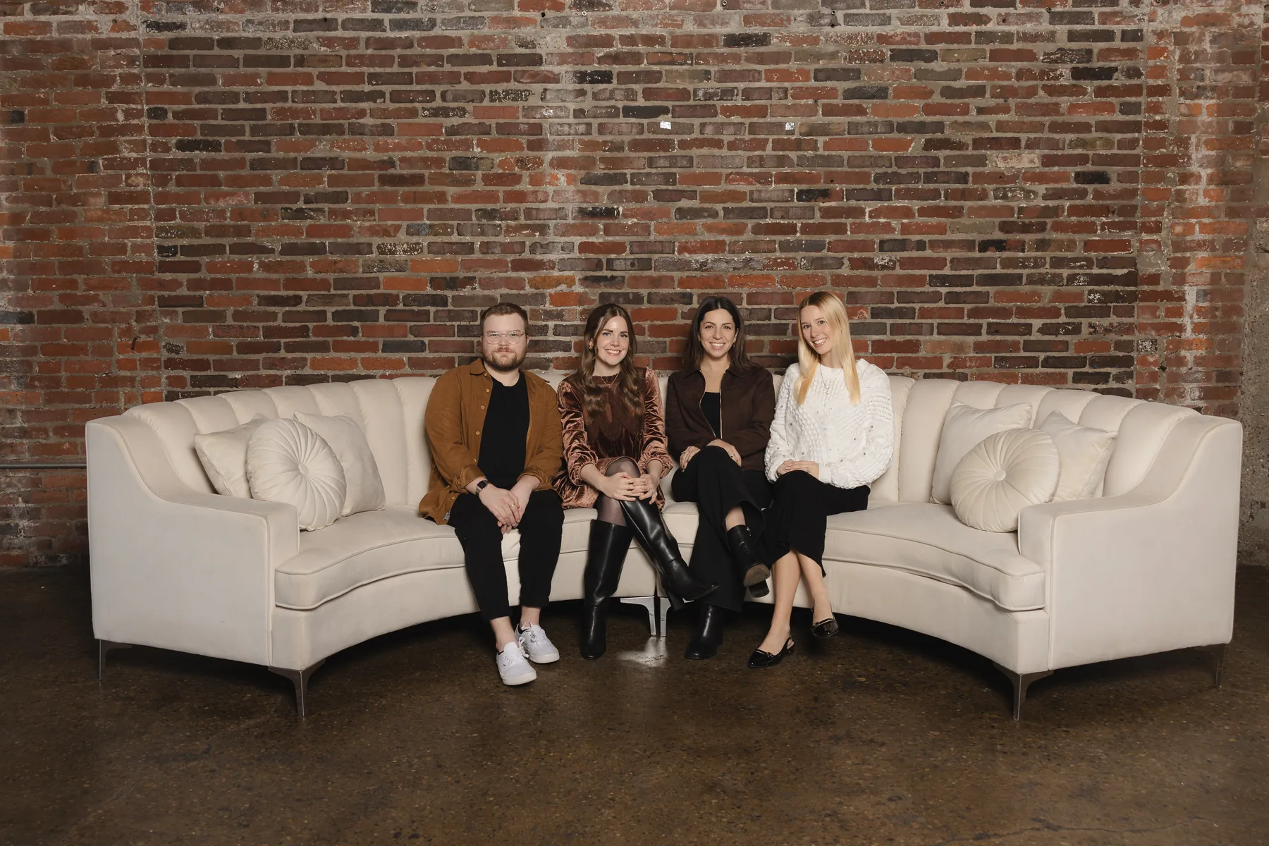 Guests seated on a Vida Sectional lounge setup by Violet Vintage Rentals at INDUSTRY in Indianapolis