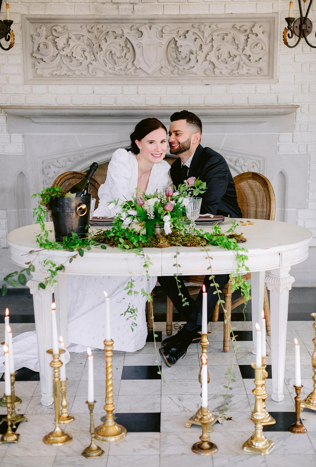 Couple seated at a romantic Laurel Hall wedding sweetheart setup with Violet Vintage rentals