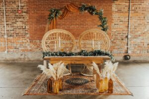 Daniela peacock chair sweetheart setting with the Genevieve Geometric Arch and Savannah Rug at a fall wedding at INDUSTRY in Indianapolis