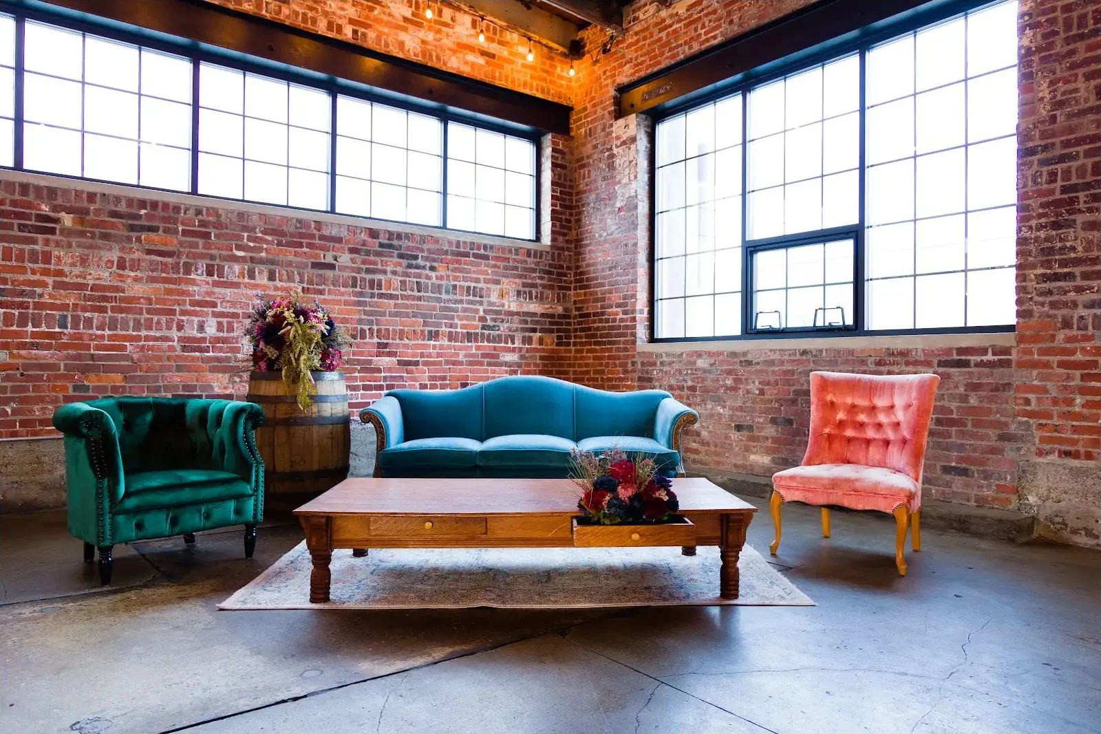 Vintage lounge setup at INDUSTRY with Swansong Sofa, Imelda Chair, Andie Chair, Vintage Barrels, and Rute Coffee Table by Violet Vintage Rentals