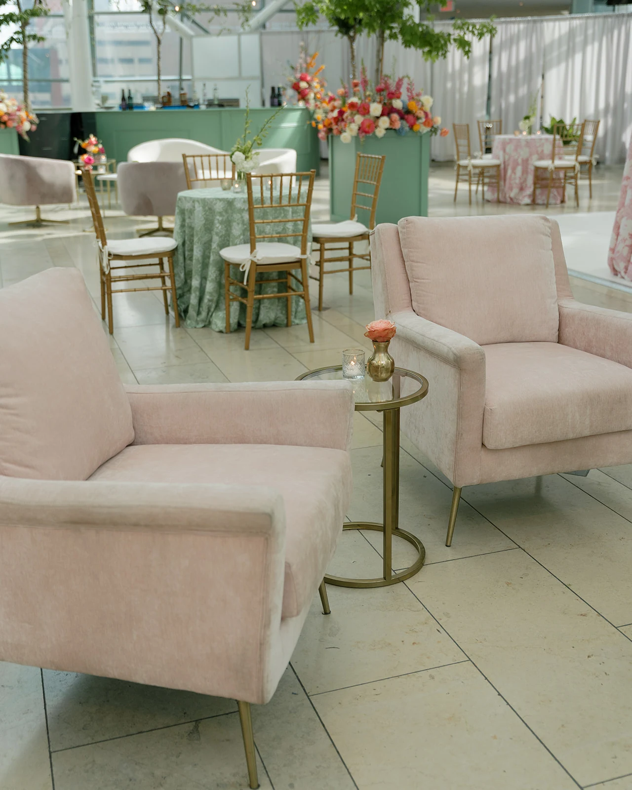 Pair of blush Nora Chairs with Aston Side Tables in an Indianapolis Artsgarden lounge